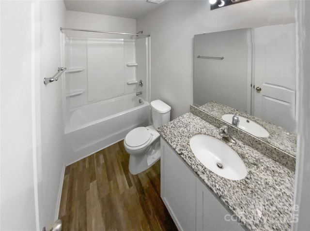 full bathroom with hardwood / wood-style flooring, toilet, vanity, and bathing tub / shower combination