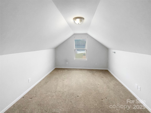 bonus room featuring carpet floors and vaulted ceiling