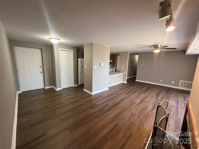 unfurnished living room with ceiling fan and dark hardwood / wood-style floors