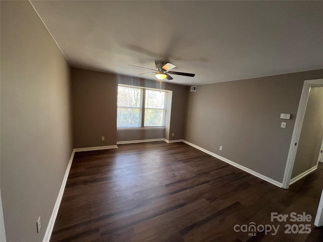 unfurnished room with ceiling fan and dark hardwood / wood-style flooring