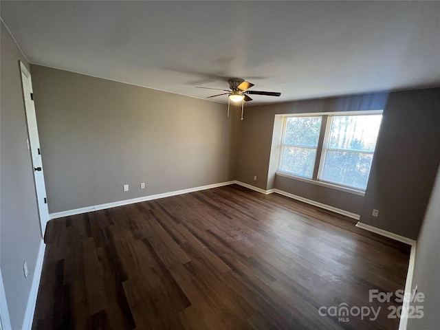 spare room with ceiling fan and dark wood-type flooring