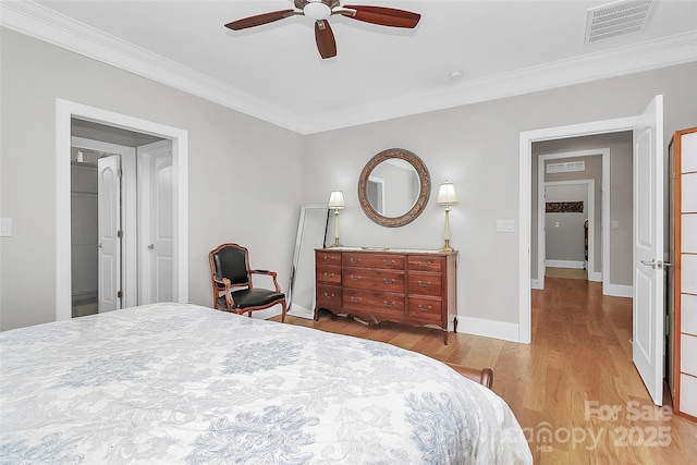 bedroom with crown molding, light hardwood / wood-style floors, and ceiling fan