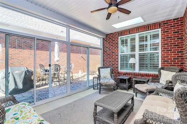 sunroom with a skylight and a ceiling fan