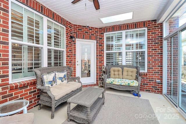 sunroom featuring a ceiling fan