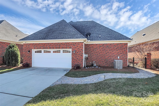 view of home's exterior with roof with shingles, brick siding, central air condition unit, fence, and driveway