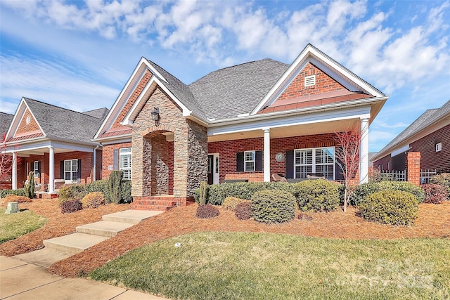 craftsman-style home featuring a front yard and covered porch