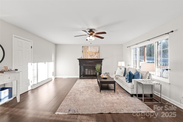 living room with ceiling fan and dark hardwood / wood-style flooring