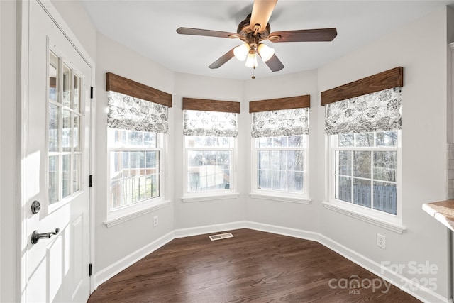 unfurnished sunroom featuring ceiling fan