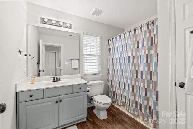 bathroom with a shower with shower curtain, vanity, wood-type flooring, and toilet