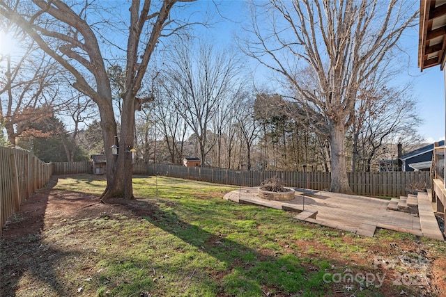 view of yard with a fire pit and a patio