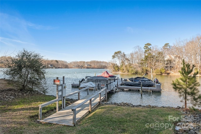 dock area featuring a water view and a yard