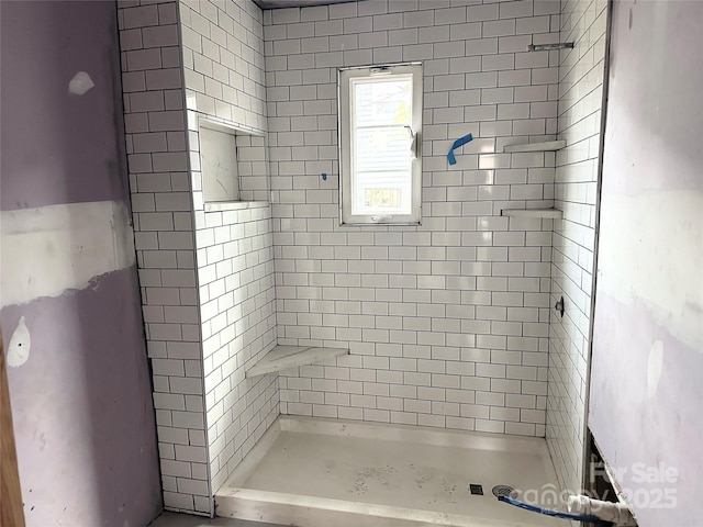 bathroom with tiled shower