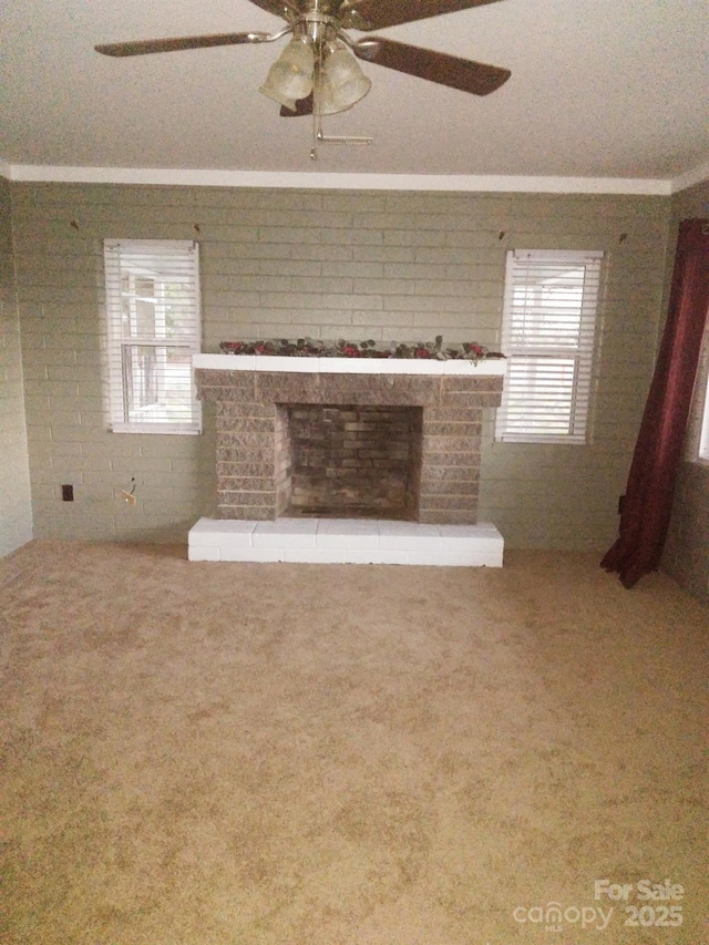 unfurnished living room with ceiling fan, carpet floors, and a brick fireplace