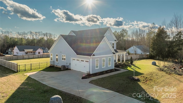 exterior space featuring a yard, central AC unit, and a garage