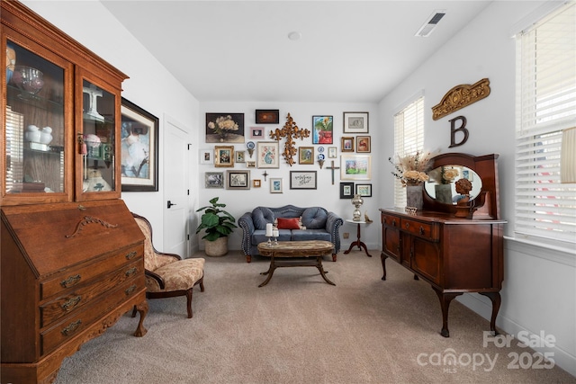 sitting room featuring light colored carpet