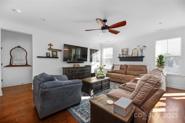 living room featuring dark hardwood / wood-style floors, ceiling fan, and crown molding