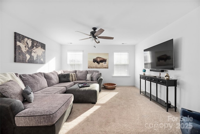 living room with ceiling fan and light colored carpet