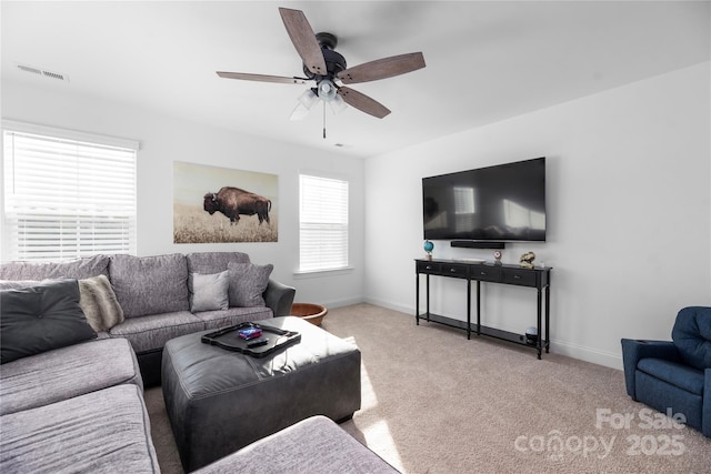 carpeted living room featuring ceiling fan