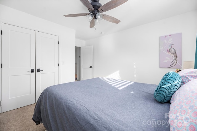 bedroom featuring ceiling fan, a closet, and carpet floors