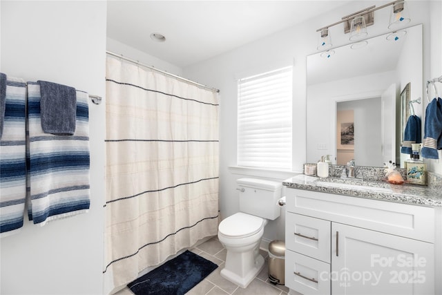 bathroom featuring tile patterned floors, curtained shower, vanity, and toilet