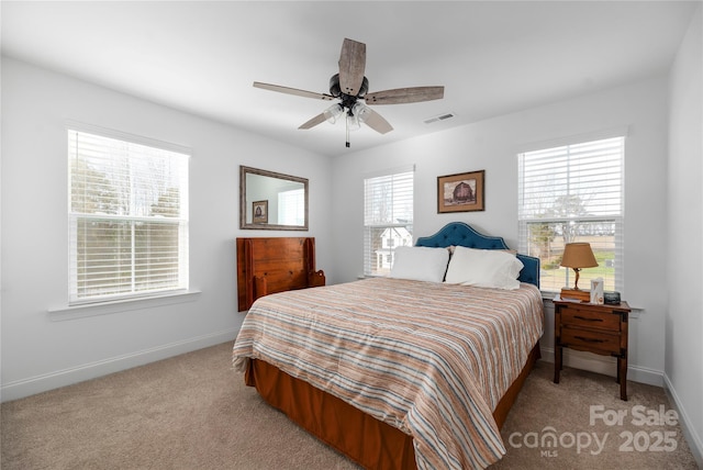 bedroom featuring ceiling fan and light carpet