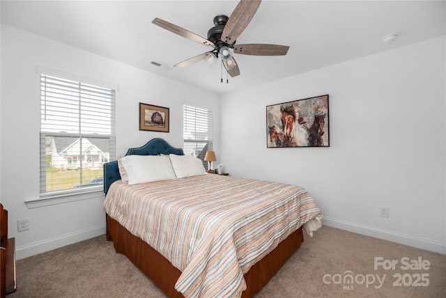 bedroom with ceiling fan and light carpet