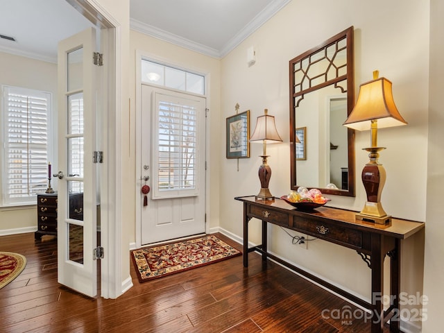 foyer entrance featuring dark hardwood / wood-style flooring and ornamental molding