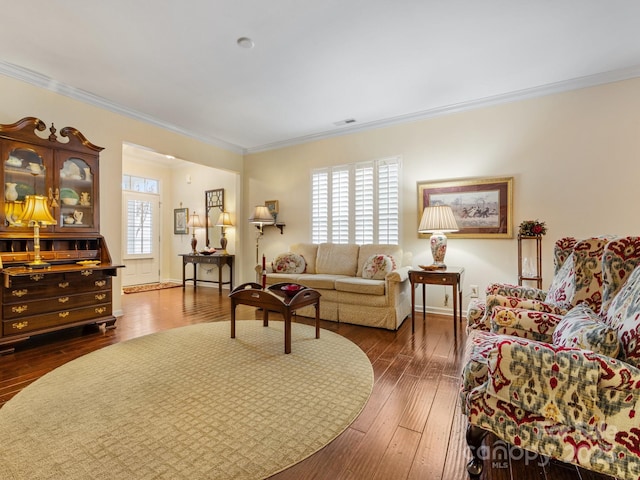 living room featuring dark wood-type flooring and ornamental molding