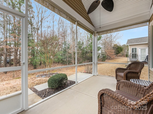 sunroom with ceiling fan and lofted ceiling