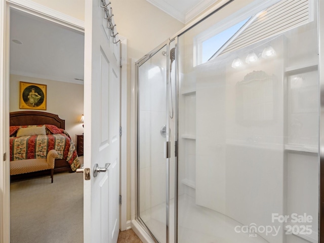 bathroom with a shower with door and ornamental molding