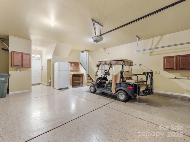 garage with white refrigerator and a garage door opener