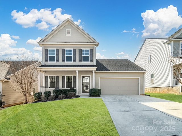 view of front of property with a front yard and a garage