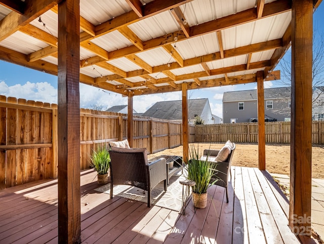 wooden terrace with a fenced backyard and an outdoor living space