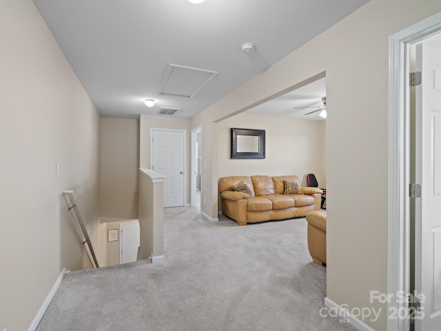 living room featuring attic access, baseboards, visible vents, and carpet flooring