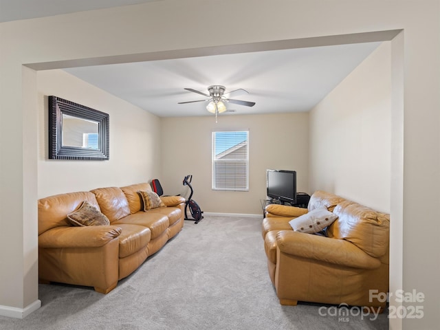 living area featuring carpet flooring, ceiling fan, and baseboards