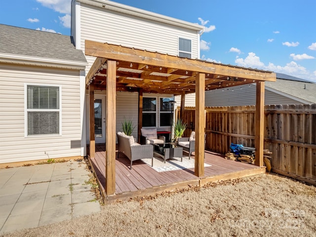 view of patio / terrace with an outdoor living space, fence, and a wooden deck