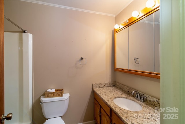 bathroom featuring toilet, crown molding, and vanity