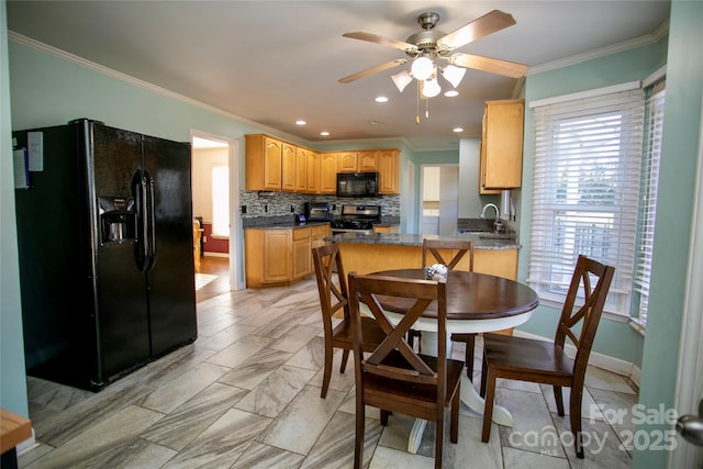 dining space featuring ceiling fan, sink, and ornamental molding