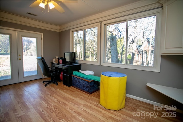 office area featuring crown molding, a wealth of natural light, light hardwood / wood-style flooring, and french doors