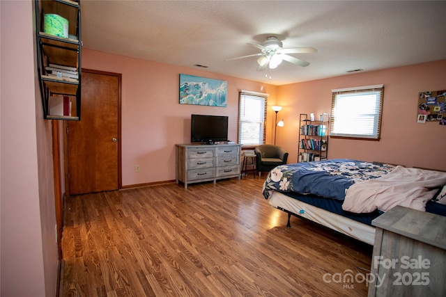 bedroom with ceiling fan and light hardwood / wood-style flooring