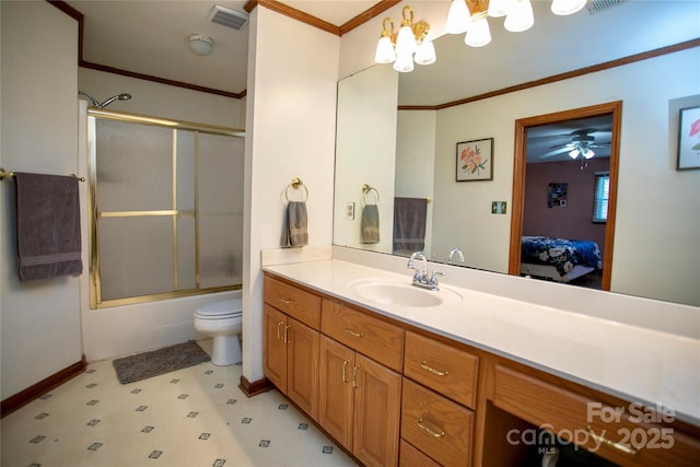 full bathroom featuring ornamental molding, combined bath / shower with glass door, vanity, and toilet