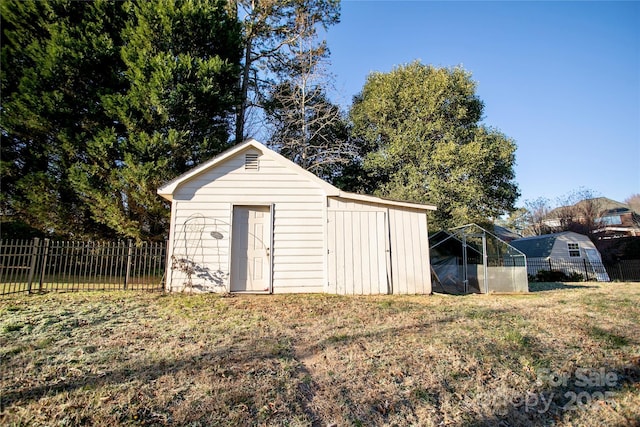 view of outbuilding with a lawn