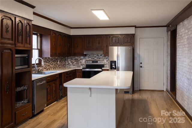 1035 Timberlane Dr, Lincolnton, NC 28092 - kitchen featuring light countertops, stainless steel appliances, dark brown cabinets, under cabinet range hood, and a sink