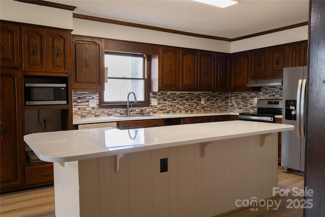 1035 Timberlane Dr, Lincolnton, NC 28092 - kitchen with a sink, light countertops, under cabinet range hood, and appliances with stainless steel finishes