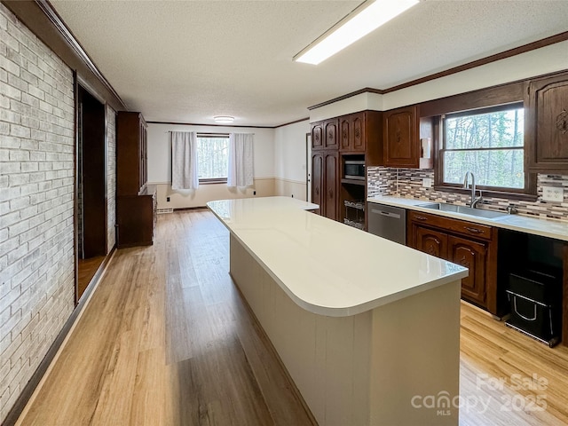 1035 Timberlane Dr, Lincolnton, NC 28092 - kitchen with light countertops, dishwasher, a sink, light wood-style floors, and a center island