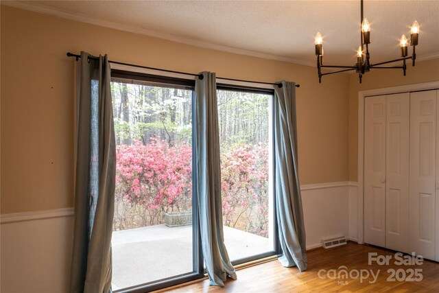 1035 Timberlane Dr, Lincolnton, NC 28092 - interior space with visible vents, crown molding, a chandelier, and wood finished floors