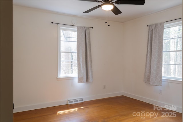 1035 Timberlane Dr, Lincolnton, NC 28092 - spare room featuring visible vents, a ceiling fan, light wood-style flooring, and a healthy amount of sunlight