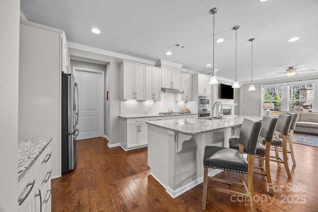 kitchen featuring light stone counters, white cabinetry, a kitchen island with sink, and stainless steel appliances