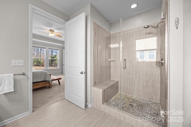 bathroom with ceiling fan and a shower with door