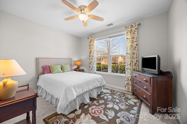 bedroom featuring light colored carpet and ceiling fan